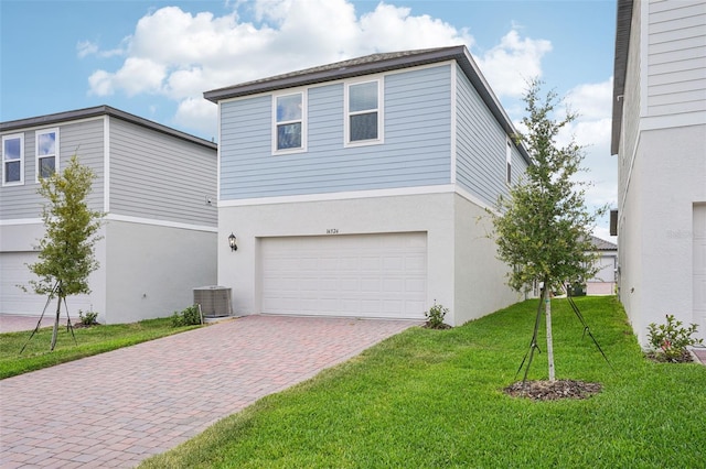 16526 Silver Brook Way, Winter Garden, FL 34787 - view of property exterior featuring an attached garage, decorative driveway, a lawn, and stucco siding