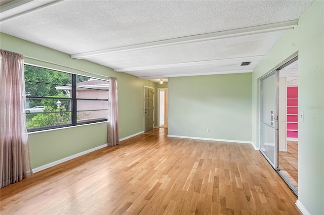 2020 Cocos Ct, Winter Park, FL 32792 - spare room featuring a textured ceiling, wood finished floors, and beam ceiling