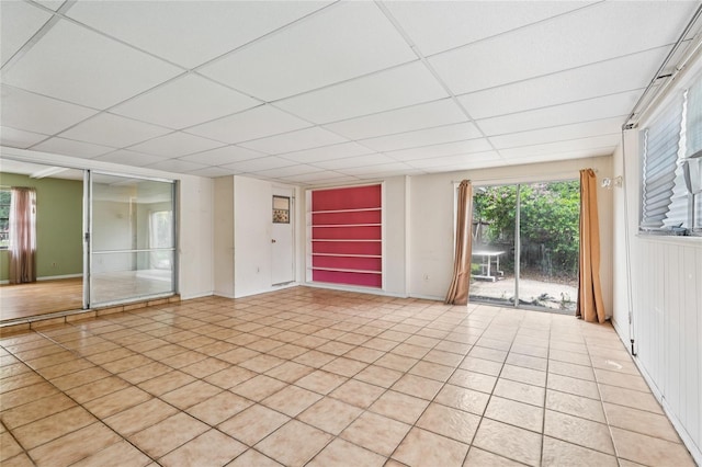 2020 Cocos Ct, Winter Park, FL 32792 - empty room featuring a paneled ceiling, light tile patterned floors, and plenty of natural light