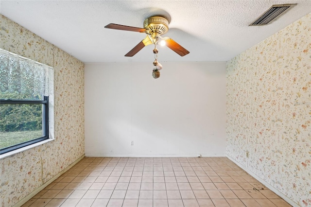 2020 Cocos Ct, Winter Park, FL 32792 - spare room featuring wallpapered walls, ceiling fan, a textured ceiling, and light tile patterned floors