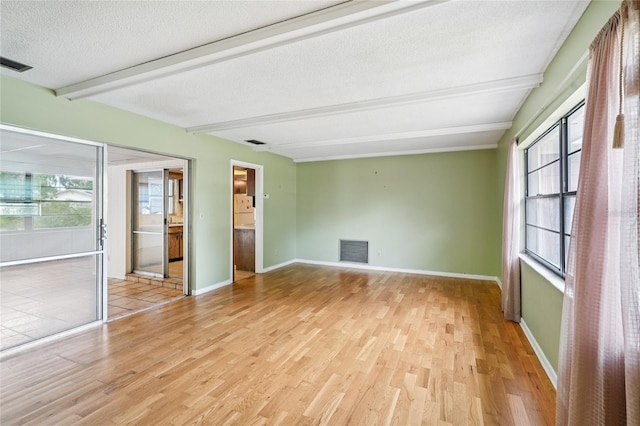 2020 Cocos Ct, Winter Park, FL 32792 - unfurnished room featuring wood finished floors, beamed ceiling, healthy amount of natural light, and a textured ceiling