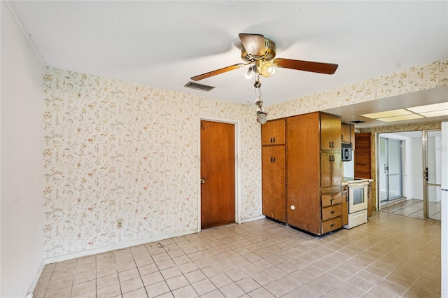 2020 Cocos Ct, Winter Park, FL 32792 - kitchen featuring white range with electric cooktop, wallpapered walls, a ceiling fan, brown cabinets, and light tile patterned floors