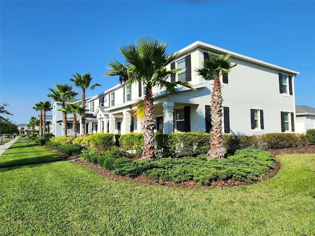 11802 Pulitzer Pl, Orlando, FL 32832 - view of side of property featuring stucco siding and a yard