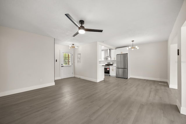 4714 Abaca St, Orlando, FL 32808 - unfurnished living room with a chandelier, wood finished floors, and ceiling fan