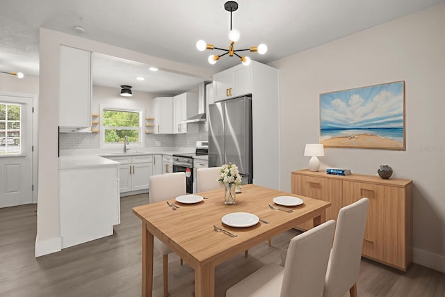 4714 Abaca St, Orlando, FL 32808 - dining space with dark wood-style floors and a chandelier