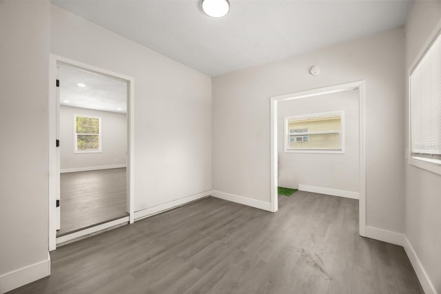 4714 Abaca St, Orlando, FL 32808 - unfurnished bedroom with wood finished floors and baseboards