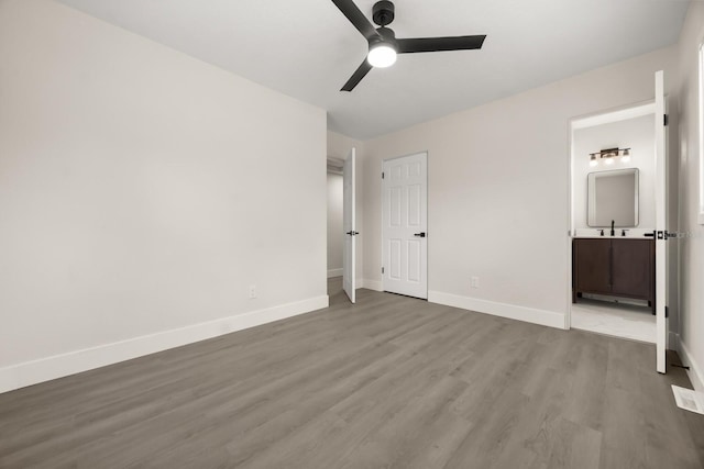 4714 Abaca St, Orlando, FL 32808 - unfurnished bedroom featuring wood finished floors, ensuite bathroom, and a ceiling fan