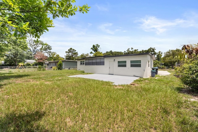 4714 Abaca St, Orlando, FL 32808 - back of property with a patio area and stucco siding