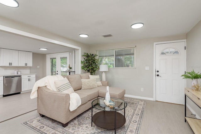 709 1st Ave NE, Largo, FL 33770 - living area with light wood-style floors and french doors
