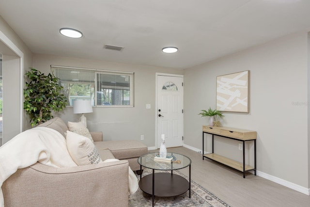 709 1st Ave NE, Largo, FL 33770 - living area with light wood finished floors and baseboards