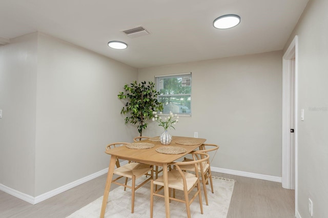 709 1st Ave NE, Largo, FL 33770 - dining room with light wood-type flooring and baseboards