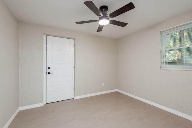 709 1st Ave NE, Largo, FL 33770 - spare room featuring light wood-style flooring, ceiling fan, and a textured wall
