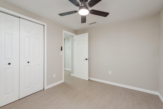 709 1st Ave NE, Largo, FL 33770 - unfurnished bedroom with light wood-style flooring, a closet, and ceiling fan
