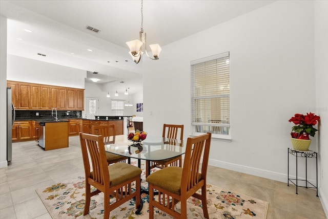18920 Overton St, Orlando, FL 32833 - dining space featuring a chandelier, light tile patterned floors, and a high ceiling