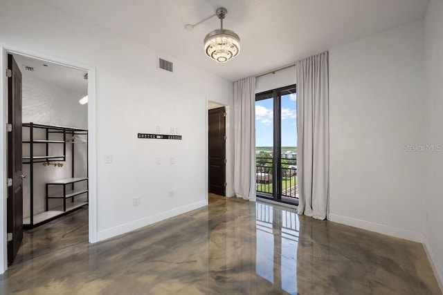 111 E Monument Ave Unit 801, Kissimmee, FL 34741 - unfurnished room featuring finished concrete floors and a chandelier