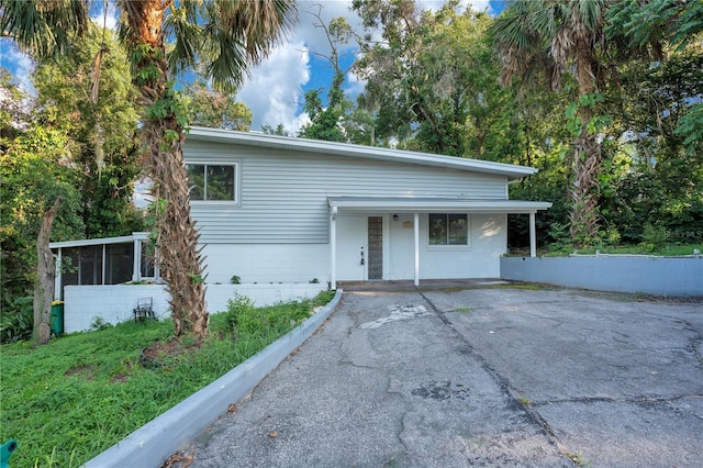 1630 Lakeview Ct, Eustis, FL 32726 - tri-level home featuring asphalt driveway and a sunroom