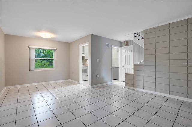 1630 Lakeview Ct, Eustis, FL 32726 - empty room featuring light tile patterned floors and stairs