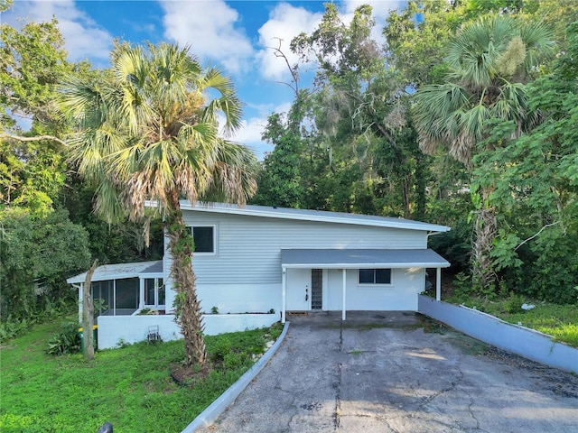 1630 Lakeview Ct, Eustis, FL 32726 - view of front facade featuring driveway and a sunroom