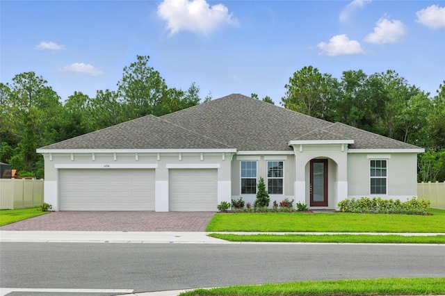 5204 Obsidian Gate Dr, Mount Dora, FL 32757 - view of front of home with a shingled roof, stucco siding, driveway, and a garage