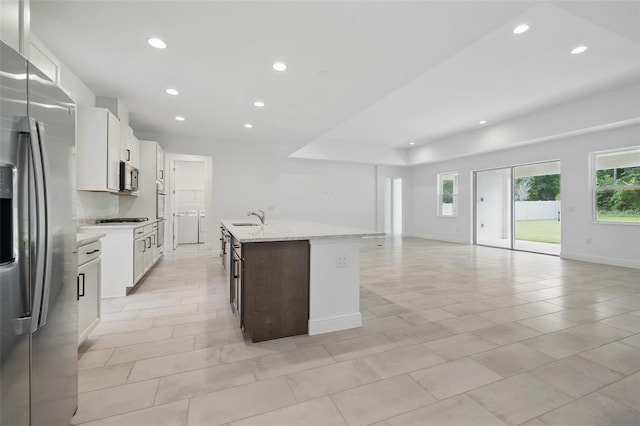 5204 Obsidian Gate Dr, Mount Dora, FL 32757 - kitchen featuring stainless steel appliances, recessed lighting, open floor plan, an island with sink, and white cabinets