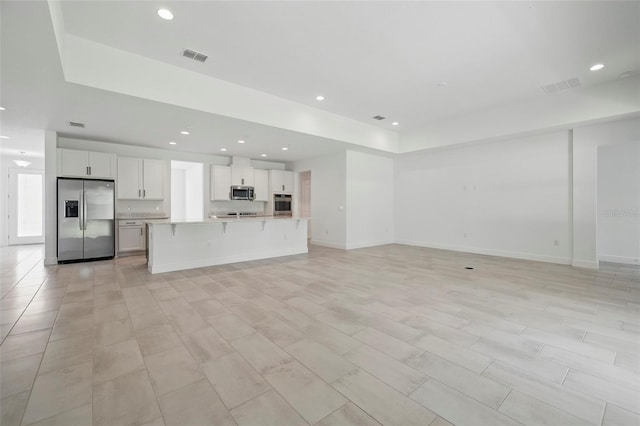 5204 Obsidian Gate Dr, Mount Dora, FL 32757 - unfurnished living room with recessed lighting and baseboards