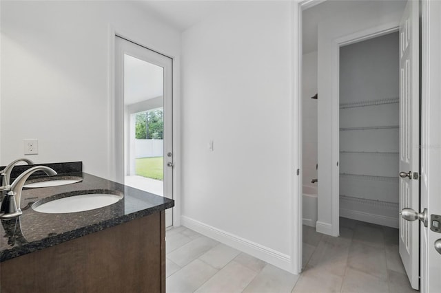 5204 Obsidian Gate Dr, Mount Dora, FL 32757 - full bath featuring double vanity, a walk in closet, and tile patterned floors