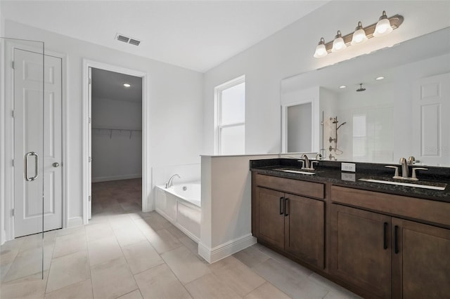 5204 Obsidian Gate Dr, Mount Dora, FL 32757 - bathroom featuring a garden tub, tiled shower, double vanity, and a walk in closet