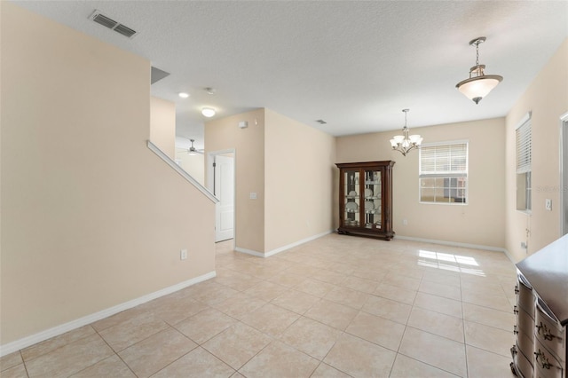 14897 Evergreen Oak Loop, Winter Garden, FL 34787 - spare room featuring a chandelier, light tile patterned floors, ceiling fan, a textured ceiling, and stairs