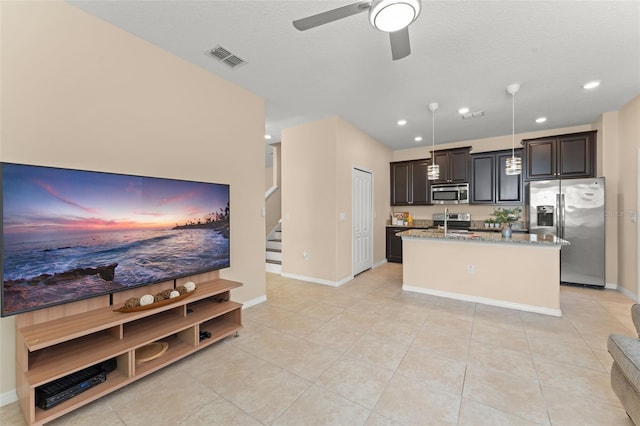 14897 Evergreen Oak Loop, Winter Garden, FL 34787 - kitchen featuring appliances with stainless steel finishes, an island with sink, light stone counters, a ceiling fan, and light tile patterned floors