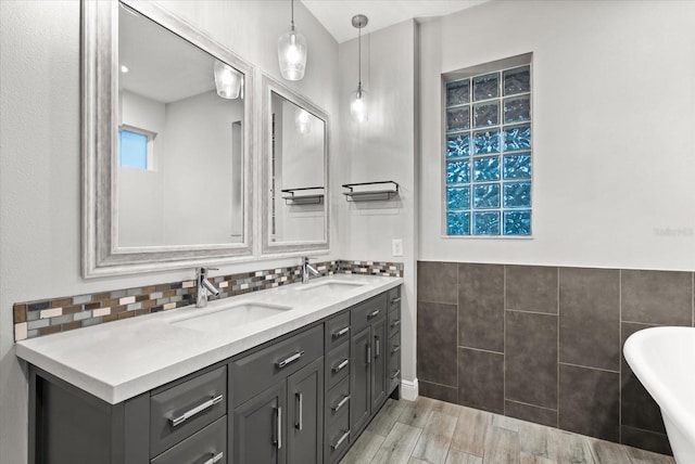 917 Southern Oak Ln, Apopka, FL 32712 - full bath featuring double vanity, a freestanding bath, tile walls, and wood finished floors