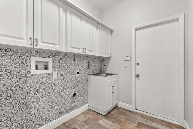 917 Southern Oak Ln, Apopka, FL 32712 - laundry room featuring hookup for an electric dryer, hookup for a washing machine, cabinet space, and light wood finished floors