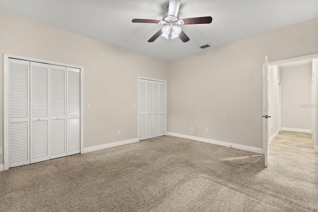 917 Southern Oak Ln, Apopka, FL 32712 - unfurnished bedroom featuring multiple closets, carpet floors, and a ceiling fan