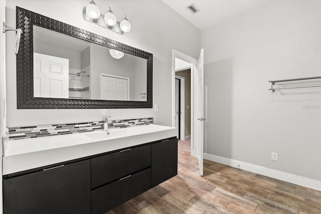 917 Southern Oak Ln, Apopka, FL 32712 - bathroom with vanity, tasteful backsplash, wood finished floors, and a shower