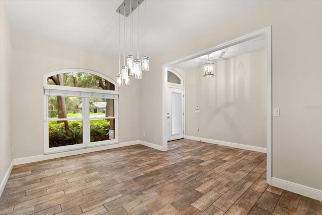 917 Southern Oak Ln, Apopka, FL 32712 - unfurnished room with a chandelier and wood finished floors