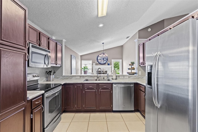 2737 Cahill Way, Lake Mary, FL 32746 - kitchen featuring stainless steel appliances, a textured ceiling, vaulted ceiling, light countertops, and light tile patterned flooring