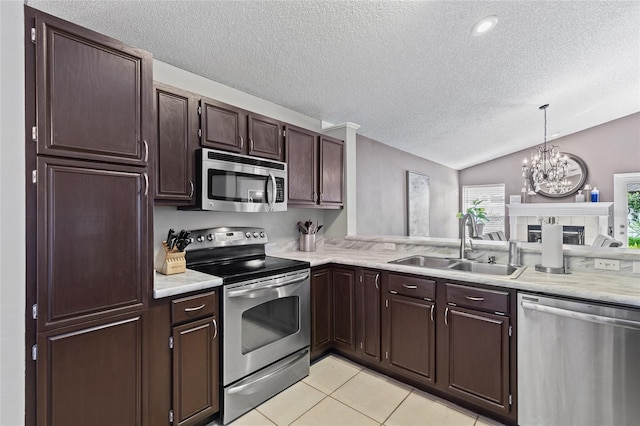 2737 Cahill Way, Lake Mary, FL 32746 - kitchen featuring appliances with stainless steel finishes, a textured ceiling, vaulted ceiling, a chandelier, and light tile patterned floors