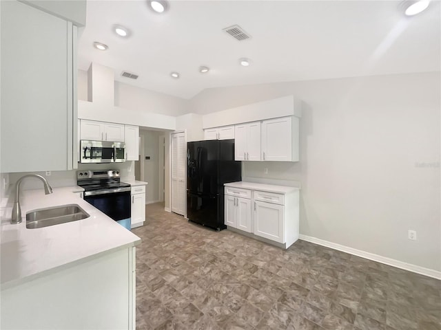 6740 Odoniel Loop W, Lakeland, FL 33809 - kitchen with stainless steel appliances, light countertops, lofted ceiling, and white cabinets