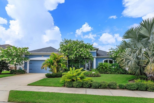 2440 Pawtucket Pass, Mount Dora, FL 32757 - view of property hidden behind natural elements with stucco siding, driveway, a front yard, and an attached garage
