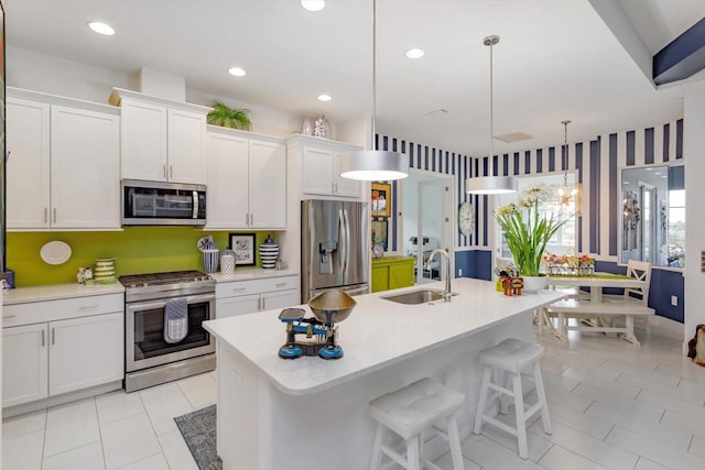 2440 Pawtucket Pass, Mount Dora, FL 32757 - kitchen with stainless steel appliances, a kitchen island with sink, light countertops, white cabinetry, and recessed lighting