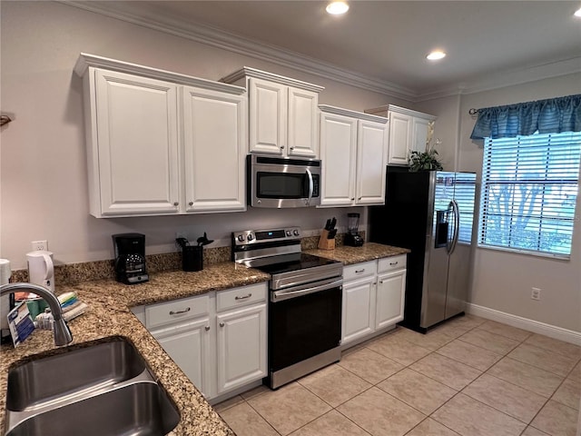 1452 Moon Valley Dr, Davenport, FL 33896 - kitchen with appliances with stainless steel finishes, white cabinetry, light tile patterned flooring, crown molding, and recessed lighting
