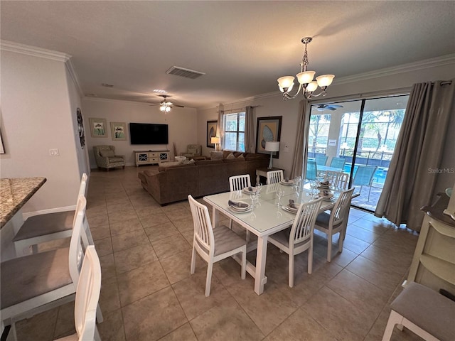 1452 Moon Valley Dr, Davenport, FL 33896 - dining space with crown molding, a chandelier, light tile patterned flooring, and ceiling fan