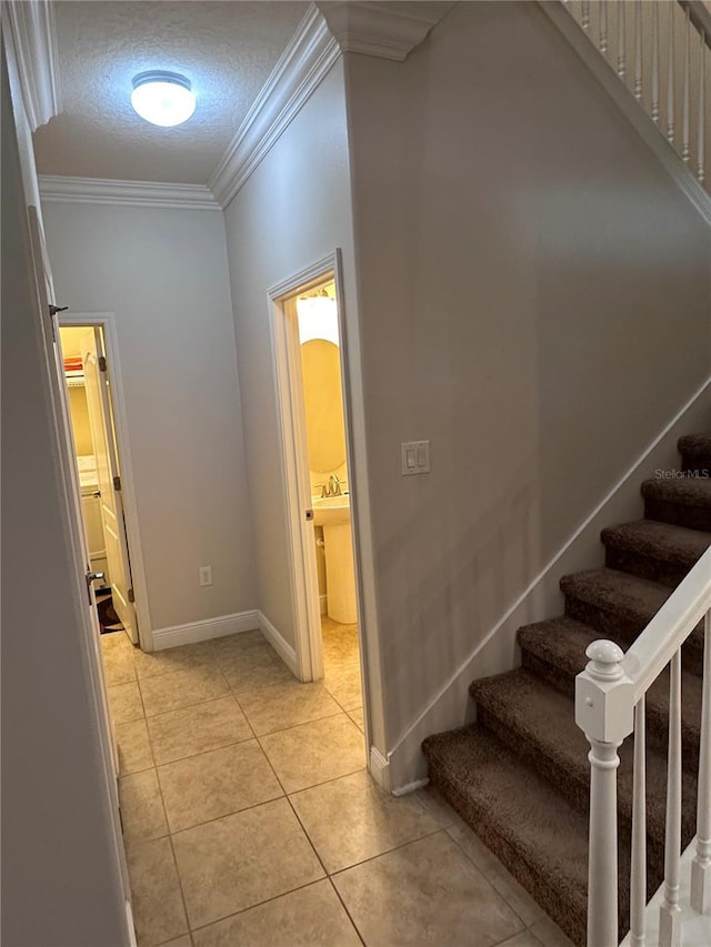 1452 Moon Valley Dr, Davenport, FL 33896 - stairs featuring crown molding, tile patterned flooring, and a textured ceiling