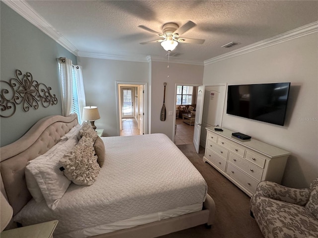 1452 Moon Valley Dr, Davenport, FL 33896 - bedroom with crown molding, a textured ceiling, a ceiling fan, and dark carpet
