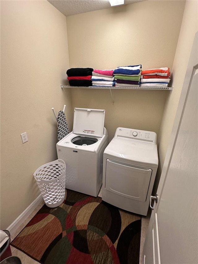1452 Moon Valley Dr, Davenport, FL 33896 - laundry room featuring separate washer and dryer and baseboards
