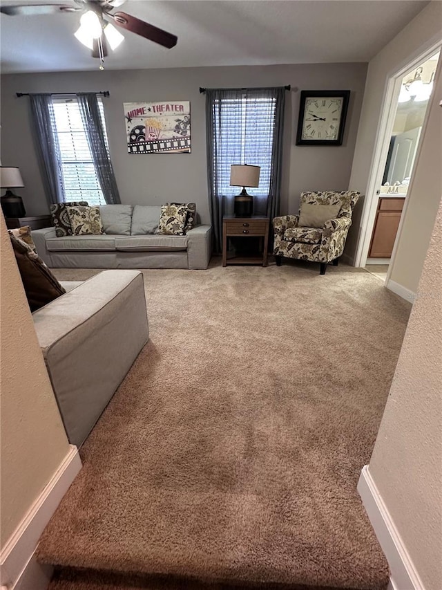 1452 Moon Valley Dr, Davenport, FL 33896 - carpeted living area featuring a ceiling fan and baseboards