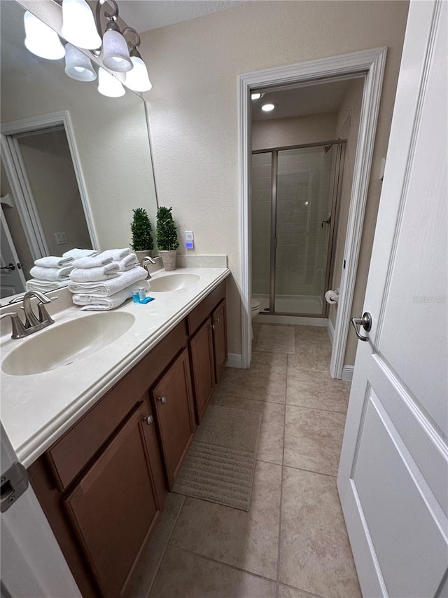 1452 Moon Valley Dr, Davenport, FL 33896 - bathroom featuring double vanity, a shower stall, a chandelier, and tile patterned floors
