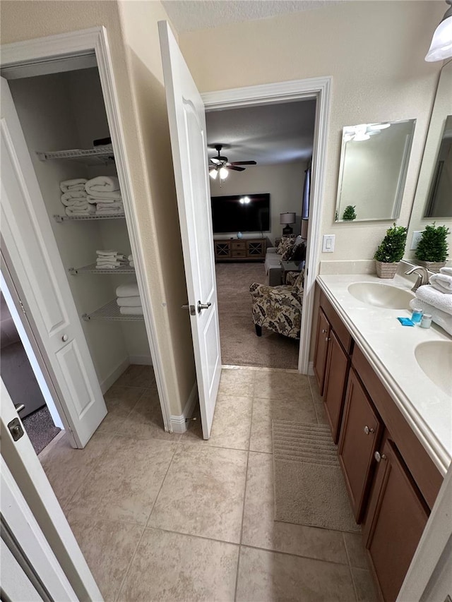 1452 Moon Valley Dr, Davenport, FL 33896 - ensuite bathroom featuring double vanity, ceiling fan, and tile patterned floors
