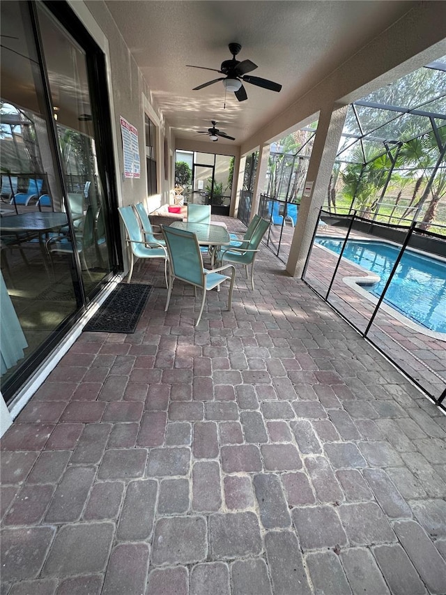 1452 Moon Valley Dr, Davenport, FL 33896 - view of patio featuring a ceiling fan, a lanai, an outdoor pool, and outdoor dining space