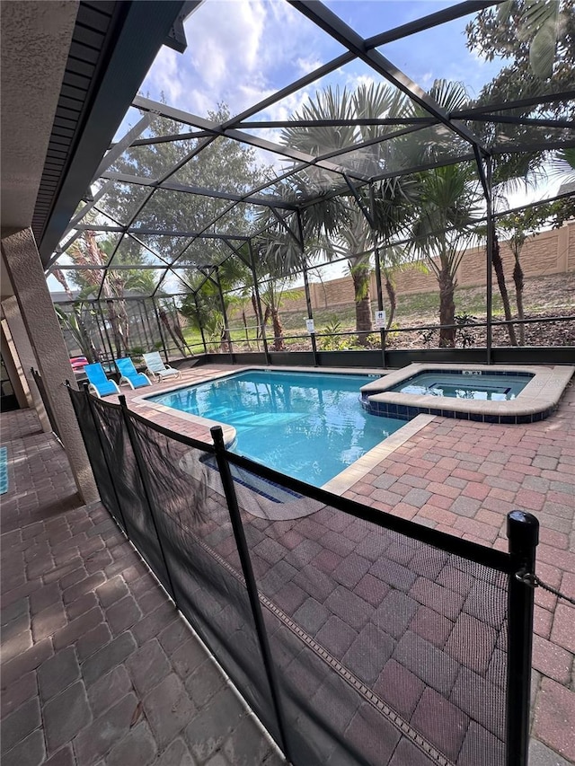 1452 Moon Valley Dr, Davenport, FL 33896 - view of swimming pool featuring glass enclosure, a patio, and a pool with connected hot tub