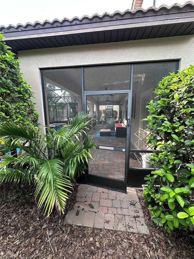 1452 Moon Valley Dr, Davenport, FL 33896 - doorway to property with stucco siding and a tiled roof